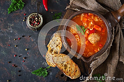 Spicy tomato soup with meatballs, pasta and vegetables. Healthy dinner. Stock Photo