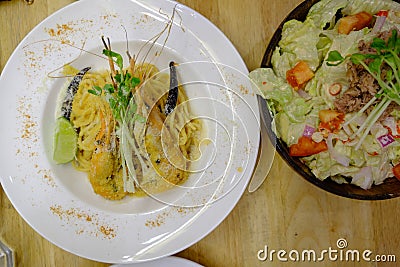 Spicy tuna salad and spaghetti with hot and sour shrimp soup sauce . Stock Photo