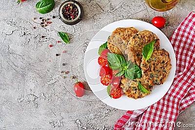 Spicy vegan burgers with rice, chickpeas and herbs. Salad tomato and basil. Stock Photo