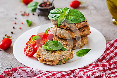 Spicy vegan burgers with rice, chickpeas and herbs. Salad tomato and basil. Stock Photo