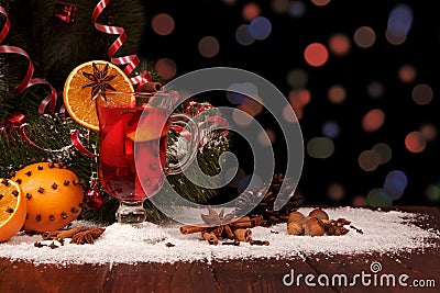 Spicy warming drink, fruits, nuts and spices on dark background Stock Photo