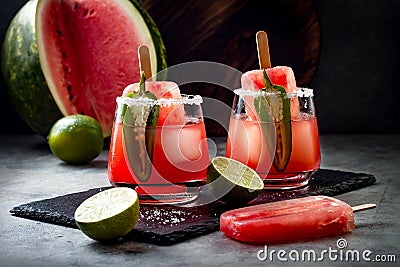 Spicy watermelon popsicle margarita cocktail with jalapeno and lime. Mexican alcoholic drink for Cinco de mayo party. Stock Photo