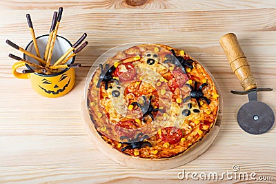 Pizza with spiders and ghosts for halloween on the table, food for halloween Stock Photo