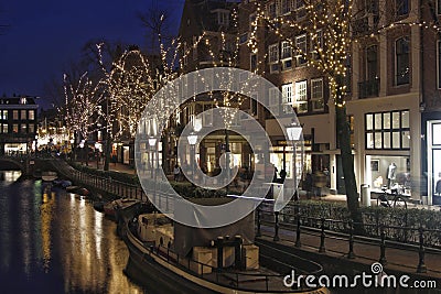 Illuminated trees and old facades in Amsterdam Editorial Stock Photo