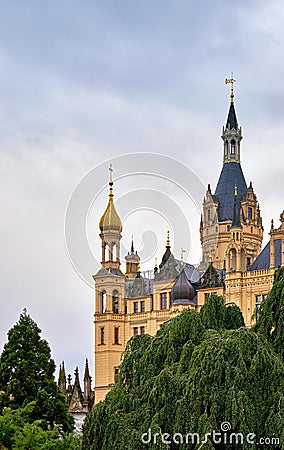 Spiers of Schwerin Castle behind big tree. Mecklenburg-Vorpommern, Pomerania, Germany Stock Photo