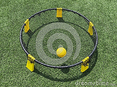 Spike ball game with yellow ball on the net Stock Photo