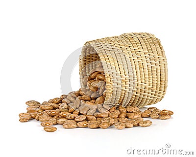 spill the beans - pinto beans spilled from basket isolated on white background Stock Photo