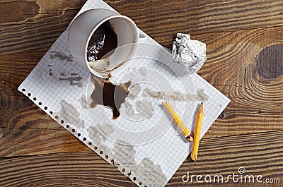 Spilled coffee, paper and pencil Stock Photo