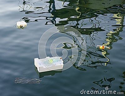 Spilled garbage on the beach of the big city. Stock Photo