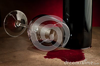 Spilled glass of wine on table after party Stock Photo