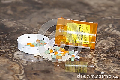 Spilled pills and controlled substances and prescription bottle Stock Photo