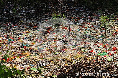 Spilled plastic garbage on the land of the big city. Empty used dirty plastic bottles. Plastic pollution. Environmental pollution. Stock Photo