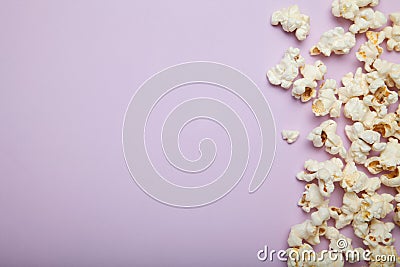 Spilled popcorn on a pink background, empty space for text Stock Photo