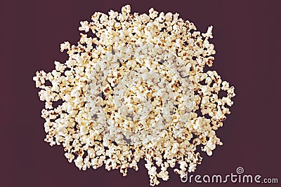 Spilled popcorn on a purple background, cinema, movies and entertainment concept Stock Photo
