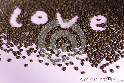 Spilled roasted coffee beans with a love inscription. Stock Photo