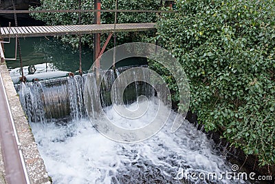 The spillway at Annecy Lake. Water flowing through the channel. Stock Photo