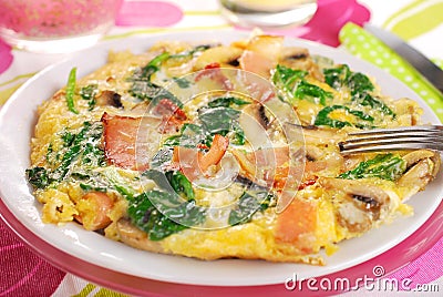 Spinach frittata with mushroom,ham and dried tomato Stock Photo