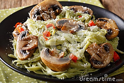 Spinach noodles with mushrooms and parmesan cheese close-up. horizontal Stock Photo