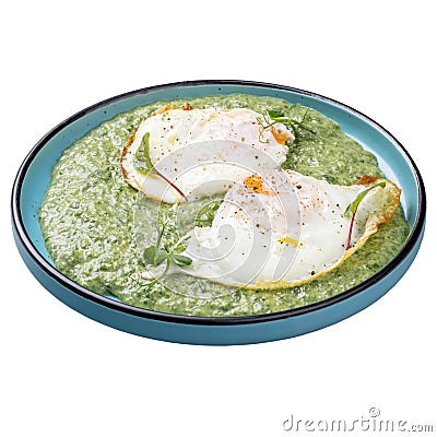 Spinach pottage with fried eggs Stock Photo
