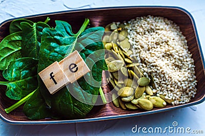 Spinach, pumpkin seeds, sesame on a white background. microelement FE. Close-up Stock Photo