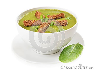 Spinach soup with dried crusts on white background Stock Photo