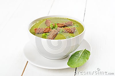 Spinach soup with dried crusts Stock Photo