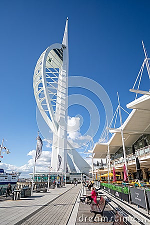Spinnaker Tower and eateries located on the harbour front of Gunwharf Quay outlet shopping centre in Portsmouth, Hampshire, UK Editorial Stock Photo