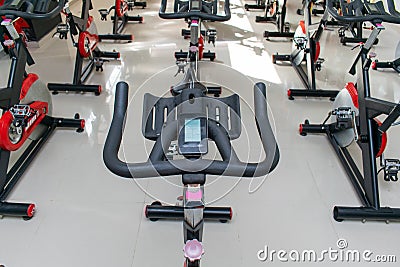 Spinning bicycles placed orderly in a room Stock Photo