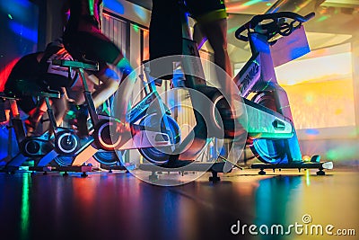 Spinning class, group activity on stationary bike. Team cardio excercise on bicycle. Stock Photo