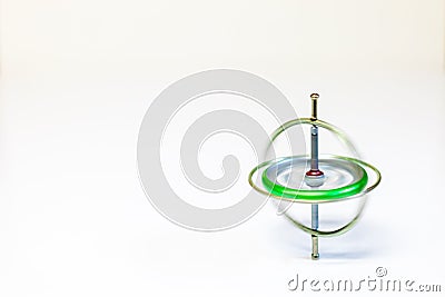 A spinning toy gyroscope isolated on a white background Stock Photo