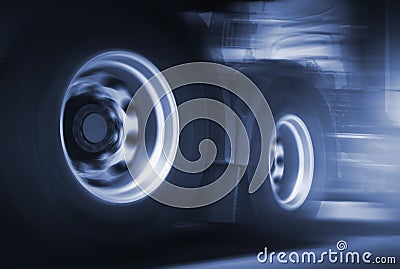 Spinning Truck Wheels. Speed of Semi Trucks Driving on the Road. Diesel Truck. Freight Truck Logistics Transport Stock Photo