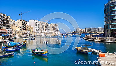 Spinola bay with fisher boats at St Julians, Malta Stock Photo
