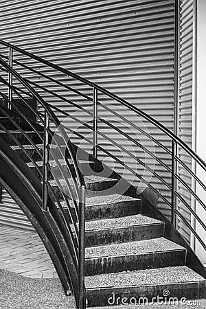 Spiral metal staircase circular staircase outdoor exterior. Staircase in a curved design with stainless railing Stock Photo