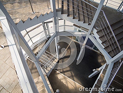 Spiral metal staircase in an overhead pedestrian crossing Stock Photo