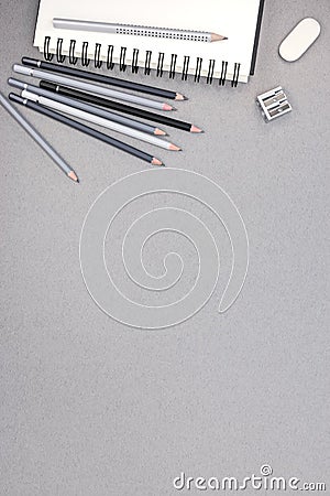 Spiral notebook, pencils, eraser, sharpener on gray recycled pap Stock Photo