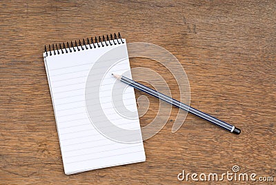 Spiral Notepad and Pencil on a wooden table Stock Photo