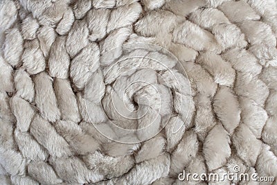 Spiral pattern of knitted natural sheep fur fabric. Stock Photo