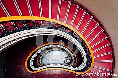 Spiral red downward staircase Stock Photo