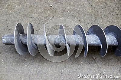 spiral shaft of the worm feeder for bulk materials Stock Photo