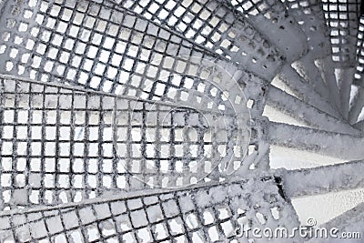 The spiral staircase is covered in snow. Dangerous descent Stock Photo