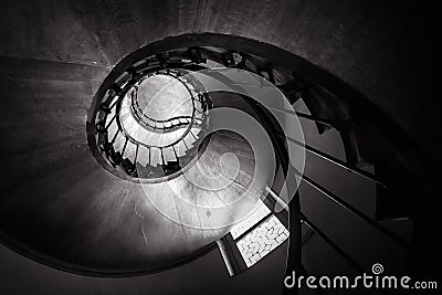 Spiral staircase in old building, bottom view of circular stair. Wooden round stairway in house interior, effect of hypnosis and Stock Photo