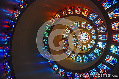 A spiraling stained glass window in the Thanks Giving Chapel Stock Photo