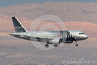 Spirit Airlines Airbus A319 regional airliner on approach to land at McCarran International Airport in Las Vegas at night Editorial Stock Photo