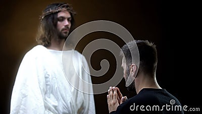 Spirit of God front of praying man, religious miracle, spiritual help, belief Stock Photo