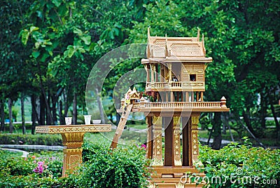 Spirit house in thailand with garland and some wreathes, joss house Stock Photo