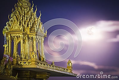 Spirit house in thailand with garland and some wreathes during the super moon Stock Photo