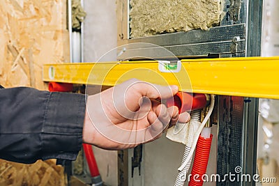 Spirit level tool in plumber hand Stock Photo
