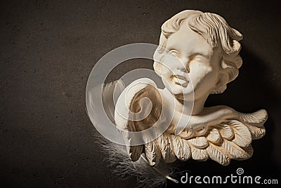 Memorial concept of angel figurine with feather Stock Photo