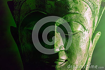 Spiritual enlightenment. Green buddha face statue close-up. Bold graphic image Stock Photo