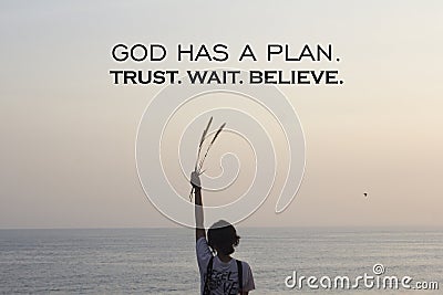 Spiritual inspirational quote - God has a plan. Trust wait and believe. On soft calm sunset light background over horizon. Stock Photo